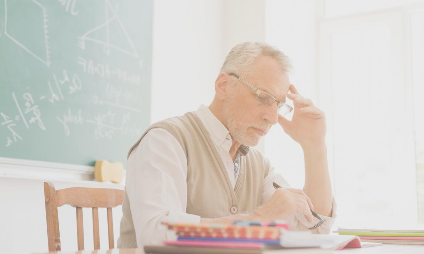 Person reviewing financial planning materials with coffee