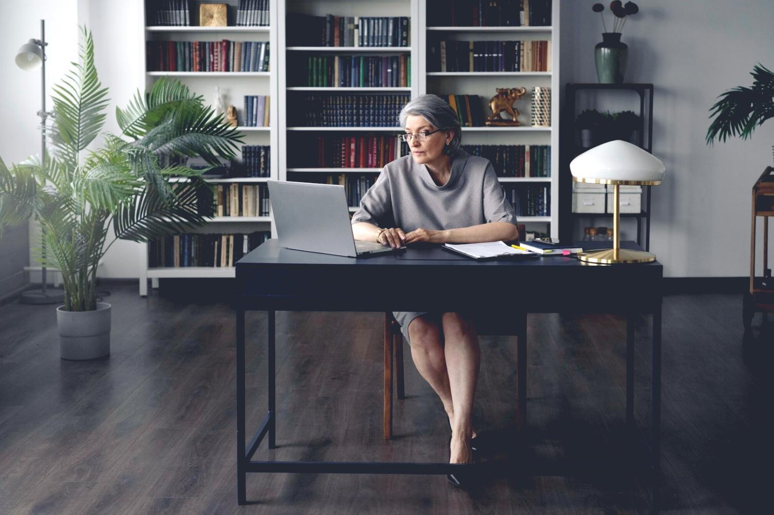 Financial planning workspace with organized documents and laptop
